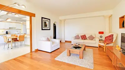 a living room with a couch and a table at Marina Sagres Apartment in Vilamoura