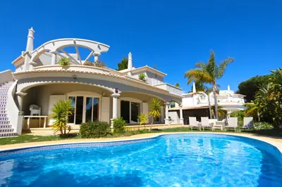 a house with a swimming pool in front of it at Villa Corvo 123- Clever Details in Vilamoura
