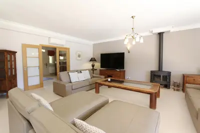 a living room with a couch and a table at Villa Corvo 123- Clever Details in Vilamoura