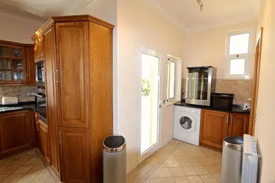 a kitchen with a washer and dryer at Villa Corvo 123- Clever Details in Vilamoura