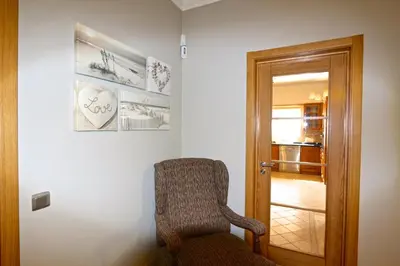 a chair sitting in a room next to a door at Villa Corvo 123- Clever Details in Vilamoura