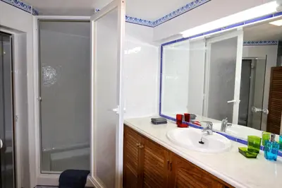 a bathroom with a sink and a shower with a mirror at Villa Corvo 123- Clever Details in Vilamoura