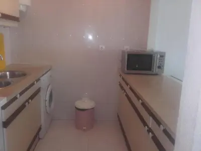 a small kitchen with a sink and a microwave at Albufeira INN - Elimar 3 T1 in Albufeira