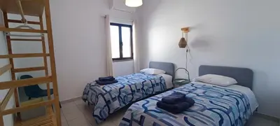 a room with two beds and a ladder at Casa do Sol in Albufeira