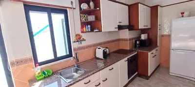 a kitchen with a sink and a refrigerator at Casa do Sol in Albufeira