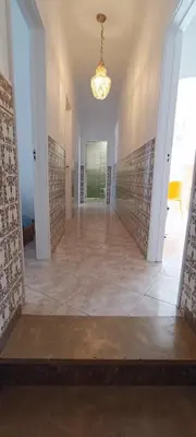 an empty hallway in a house with a chandelier at Casa do Sol in Albufeira