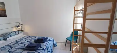 a bedroom with a bunk bed and a ladder at Casa do Sol in Albufeira