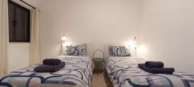 two beds sitting next to each other in a room at Casa 