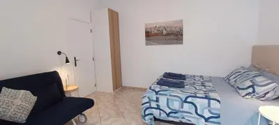 a bedroom with a bed and a couch and a chair at Casa 