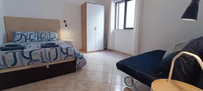 a bedroom with a bed and a couch in it at Casa 