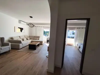 a living room with a couch and a table at Praia dos Aveiros T1 - Albufeira INN in Albufeira