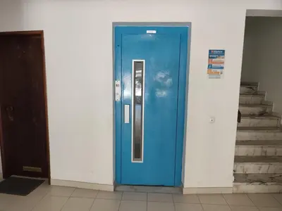 a blue door in a room with stairs at Praia dos Aveiros T1 - Albufeira INN in Albufeira