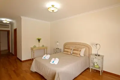a bedroom with a bed with two slippers on it at Moura Praia - Clever Details in Vilamoura