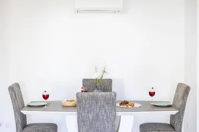 a dining room table with two chairs and wine glasses at Garden Hill Relax & Old Town by OCvillas in Albufeira