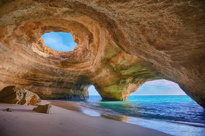 a large rock formation on a beach with the ocean at Marina Vilamoura Aquamar 504 by VilamouraSun in Vilamoura