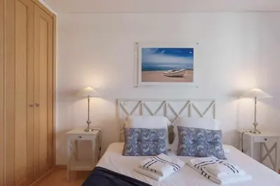 a bedroom with a bed with two pillows on it at Marina Vilamoura Aquamar 504 by VilamouraSun in Vilamoura