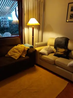 a living room with a couch and a lamp at House with beautiful garden and swimming pool in Quarteira