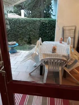 a table and chairs on a patio with a table and a table and chairs at House with beautiful garden and swimming pool in Quarteira