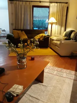 a living room with a couch and a table at House with beautiful garden and swimming pool in Quarteira