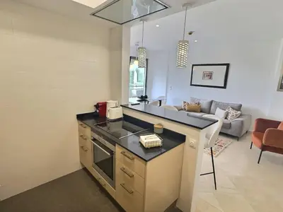 a kitchen with a counter top and a living room at Marina Vilamoura - Aquamar 301 - By Vilamoura Sun in Vilamoura