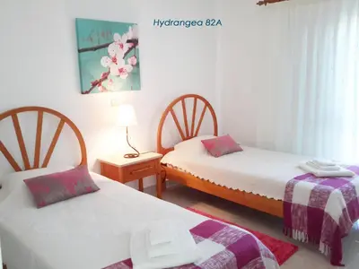 a bedroom with two beds with red towels on them at Apartamentos São Rafael - Albufeira, Algarve in Albufeira
