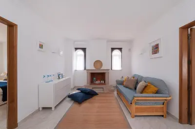 a living room with a blue couch and a fireplace at Vila dos Girassóis - BlueSea in Albufeira
