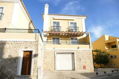 a large yellow building with a door and a window at Encosta das Oliveiras 49D in Vilamoura