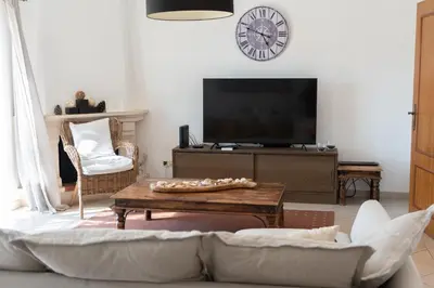 a living room with a couch and a tv at Encosta das Oliveiras 49D in Vilamoura