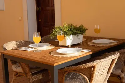 a wooden table with two glasses of orange juice at Encosta das Oliveiras 49D in Vilamoura