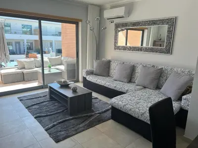 a living room with a couch and a table at Vila Branca in Albufeira