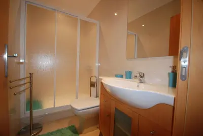 a bathroom with a sink and a toilet and a shower at Vila Branca in Albufeira