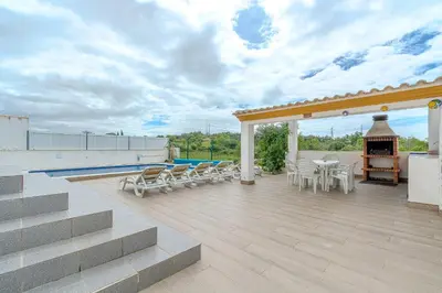 a patio with chairs and a fireplace on a roof at Villa Monica - POOL HEATED - By Algarkasa in Albufeira