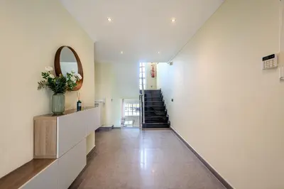 a hallway with a staircase and a vase of flowers at Villa Monica - POOL HEATED - By Algarkasa in Albufeira
