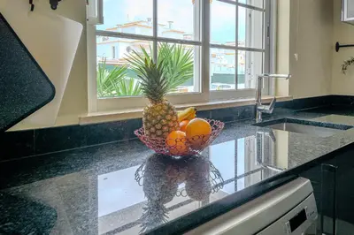 a bowl of fruit sitting on a counter in a kitchen at Villa Monica - POOL HEATED - By Algarkasa in Albufeira