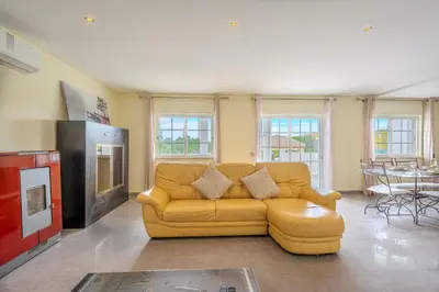 a living room with a yellow couch and a table at Villa Monica - POOL HEATED - By Algarkasa in Albufeira