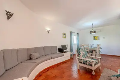 a living room with a couch and a chair at Villa Amendoeira-POOL HEATED - By Algarkasa in Guia