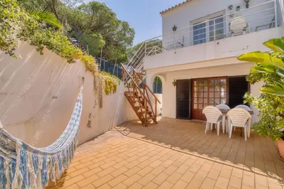 a patio with chairs and a staircase in a house at Casa Teles in Quarteira