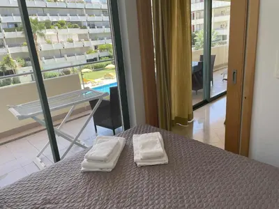 a bedroom with a bed with two towels on it at Marina Vilamoura - Aquamar 112 - By Vilamoura Sun in Vilamoura