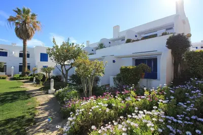 a white house with flowers in front of it at Windmill Hill in Albufeira
