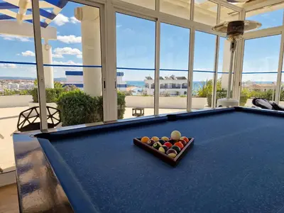 a pool table with a box of balls on it at Windmill Hill in Albufeira