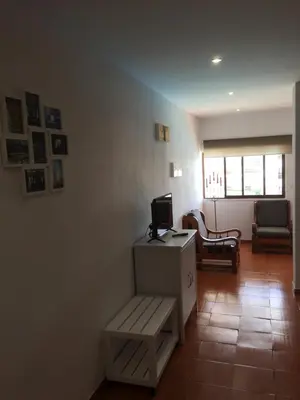 a room with a desk with a computer and a chair at Charmosous Flat in Albufeira