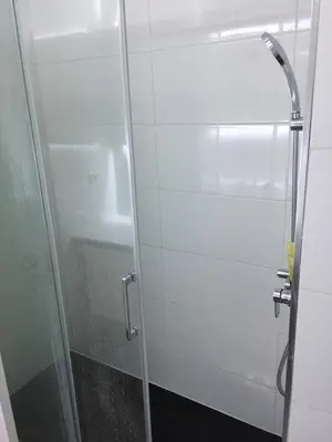 a shower with a glass door in a bathroom at Charmosous Flat in Albufeira