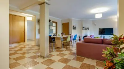 a living room with a couch and a table at Villa Girassol in Vilamoura