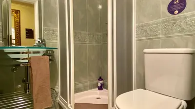 a bathroom with a shower and a toilet and a sink at Downtown by Check-in Portugal in Faro