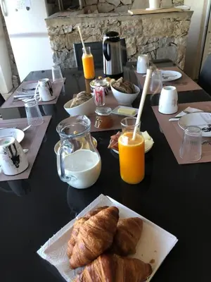 a table with a breakfast of croissants and orange juice at Felicidade in Loulé