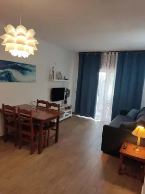 a living room with a table and a couch at Vieira apartment 1 in Quarteira
