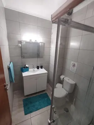 a bathroom with a toilet and a sink and a shower at Vieira apartment 1 in Quarteira