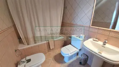 a bathroom with a white toilet and a sink at Apartamento AH in Guia