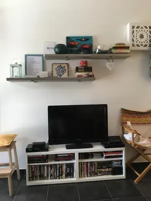 a flat screen tv sitting on a white entertainment center at Estúdio tranquilo praia da Falésia in Albufeira