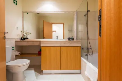 a bathroom with a toilet and a sink and a shower at Vista das Ondas by Algarneto in Albufeira